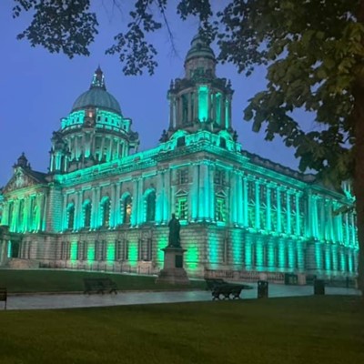 Belfast City Hall lit up in green for Aching Arms