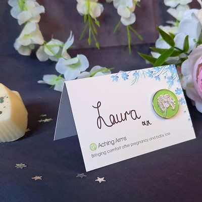 side view forget me not flower design wedding favour with green Aching Arms enamel pin badge