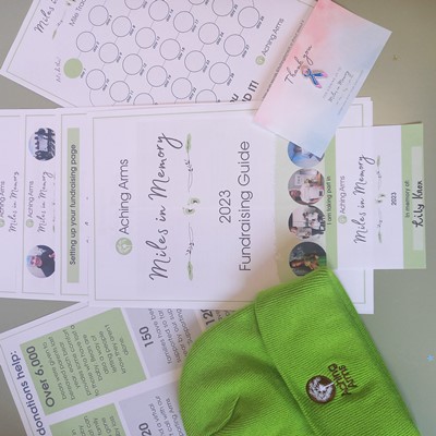 miles in memory fundraising pack with baby loss awareness pin badge and aching arms beanie hat