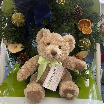 Aching Arms Comfort Bear displayed with Christmas Wreath made at our Be Together Event